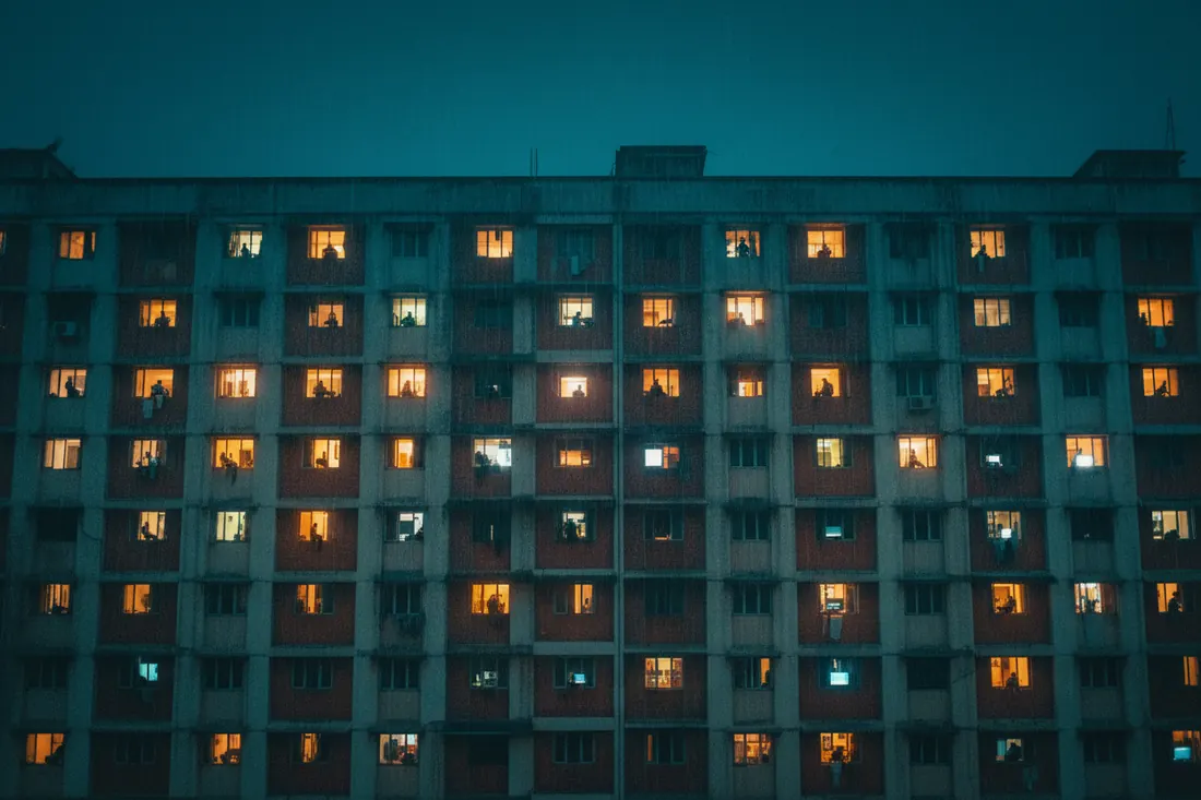 Apartment windows lit at night